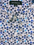 Close-up of a shirt with a floral pattern and 'mechmoto' label.