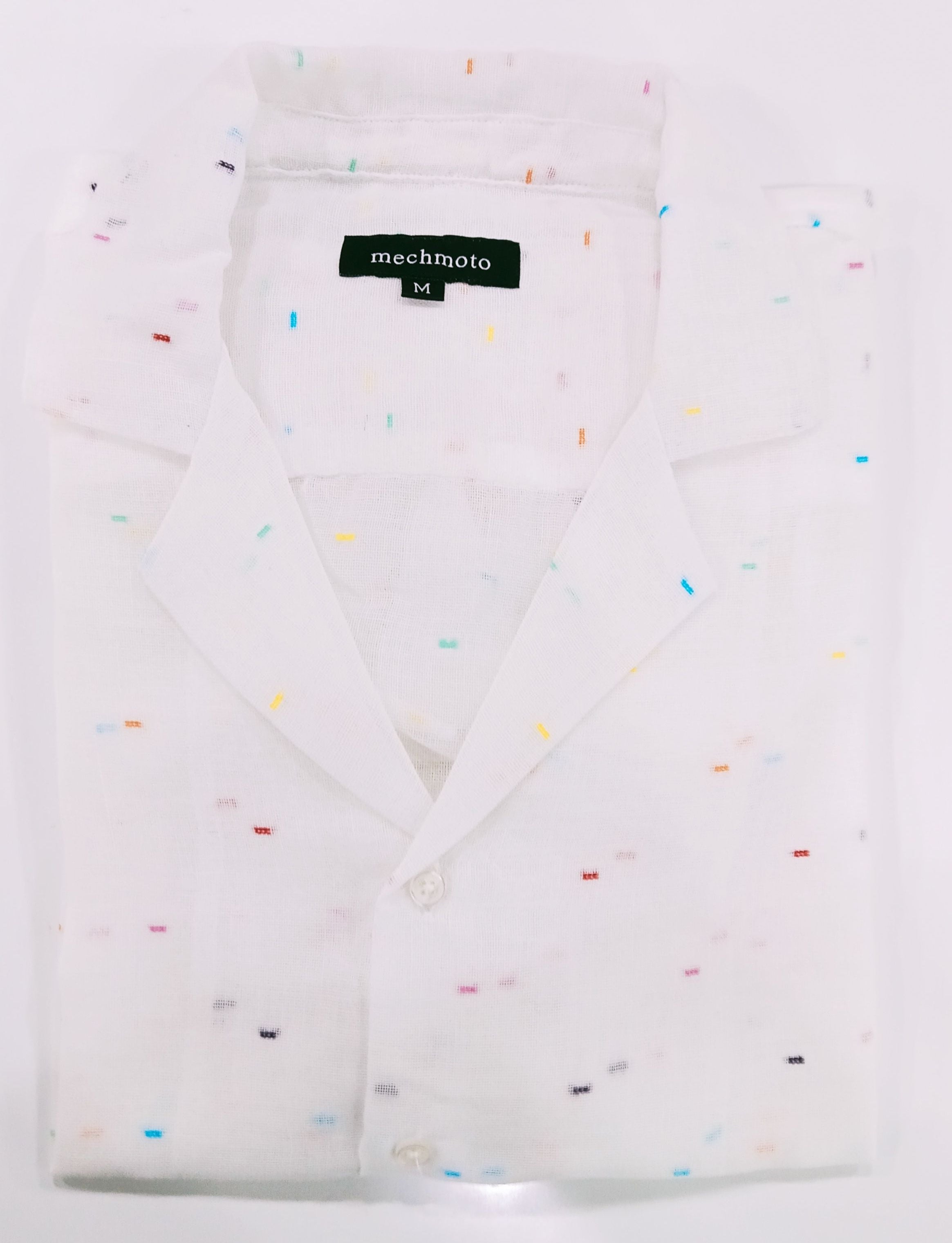White shirt with colorful speckles on a white background