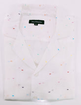 White shirt with colorful speckles on a white background