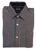 Folded plaid shirt on a white surface with a blurred background