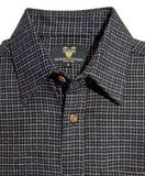 Plaid shirt with buttons on a white surface