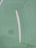 Green polo shirt with a small logo on a light green background