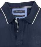Folded navy blue polo shirt with white trim on a gray background