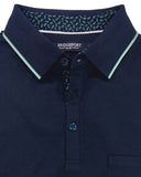 Folded navy blue polo shirt with green trim on a white background