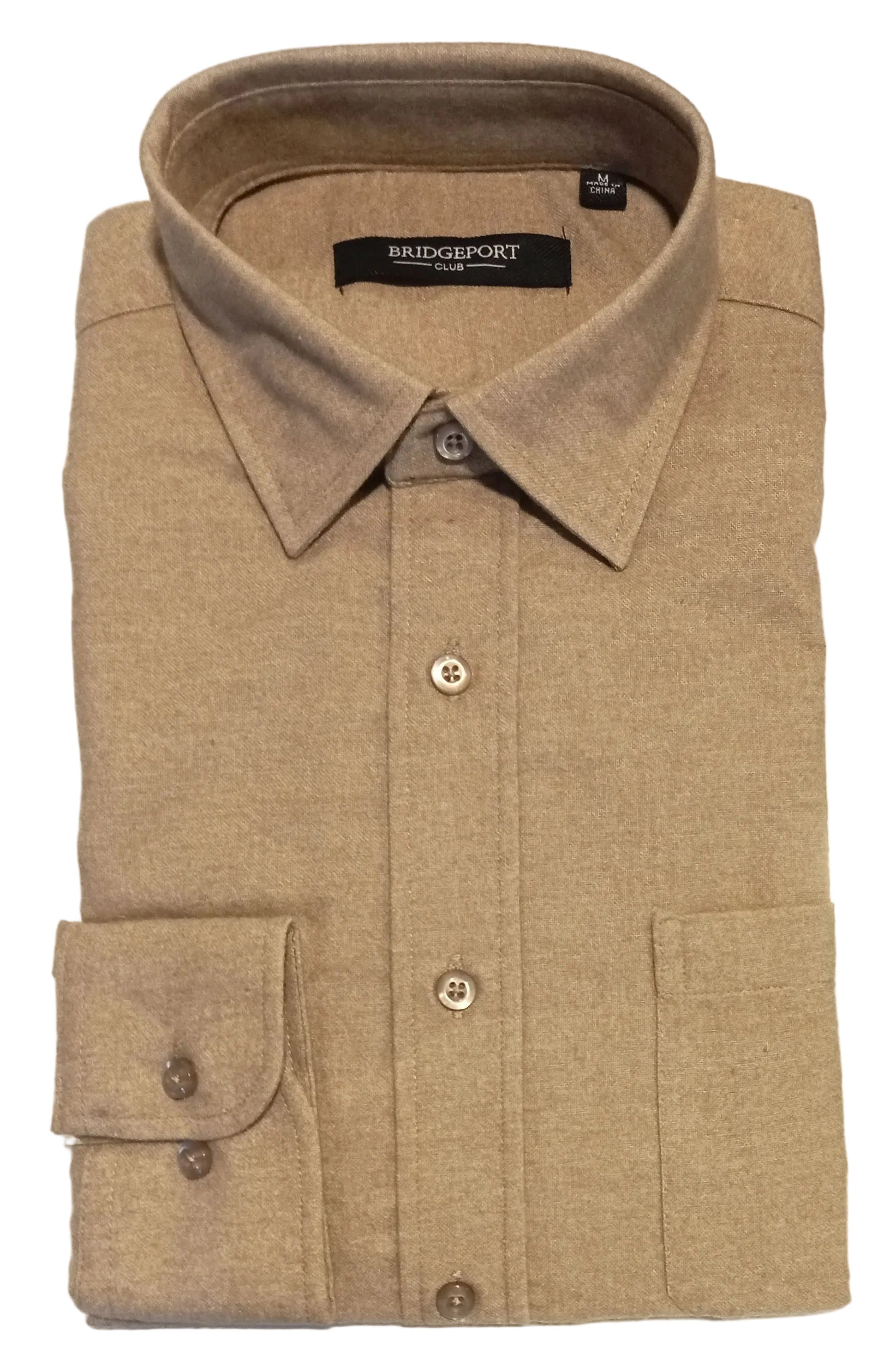 Beige shirt on a white surface with a desk in the background