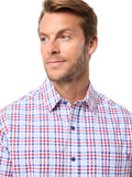 Man wearing a red, white, and blue checkered shirt against a light background