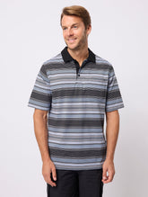 Man wearing a striped polo shirt against a plain background