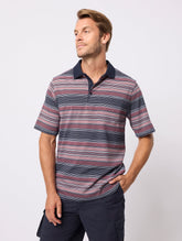 Man wearing a striped polo shirt against a plain background