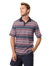 Man wearing a striped polo shirt against a plain background