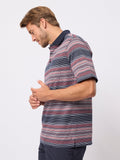 Man wearing a striped polo shirt on a white background
