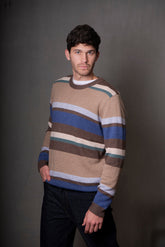 Man wearing a striped sweater against a plain background