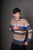 Man wearing a striped sweater against a gray background