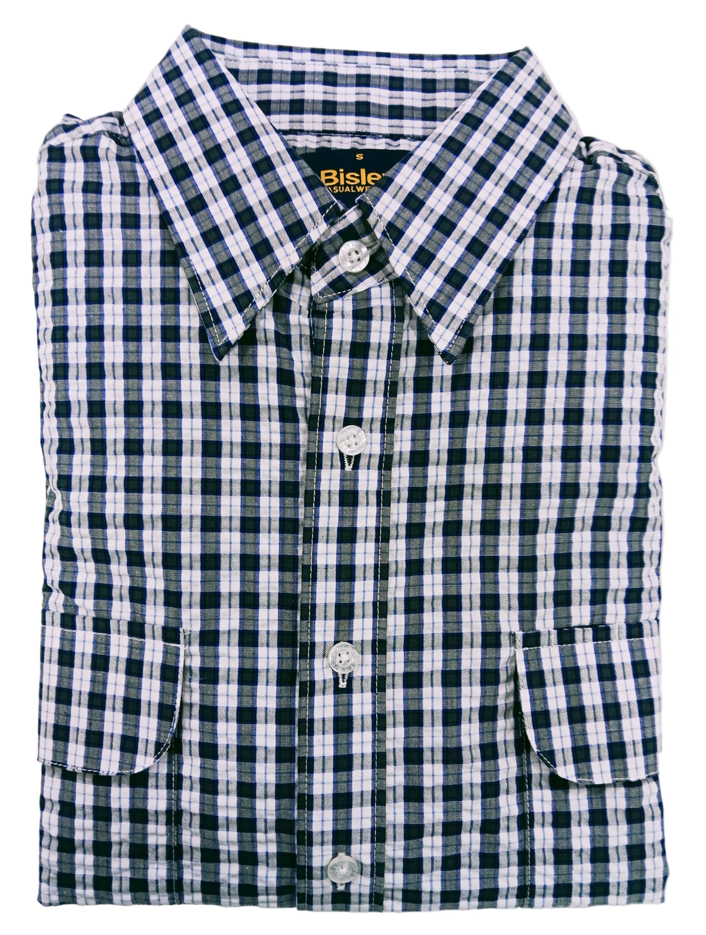 Folded green and white checkered shirt on a light gray background