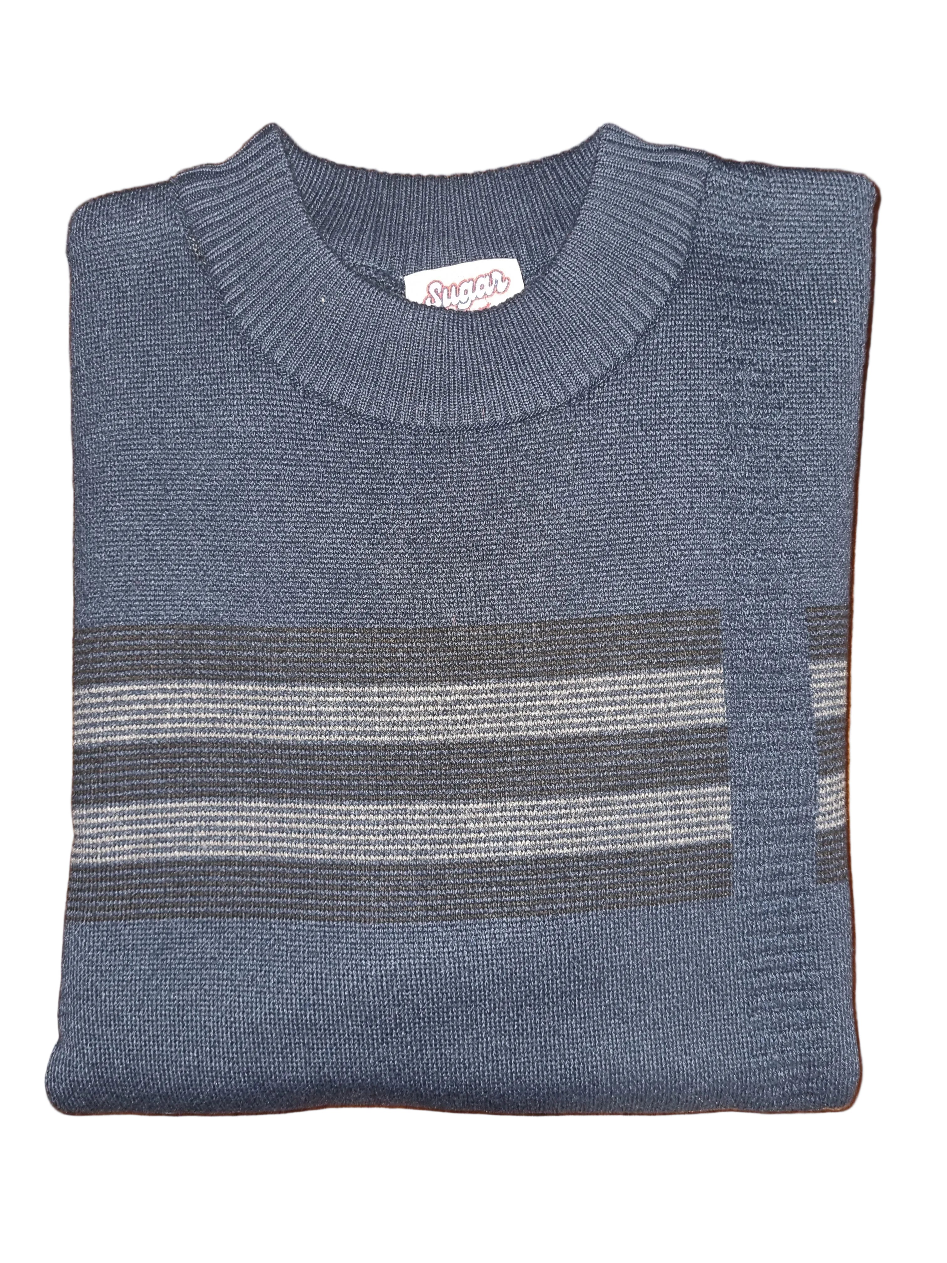 Folded blue sweater with striped pattern on a wooden surface