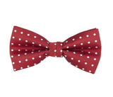 Red bow tie with white polka dots on a white background
