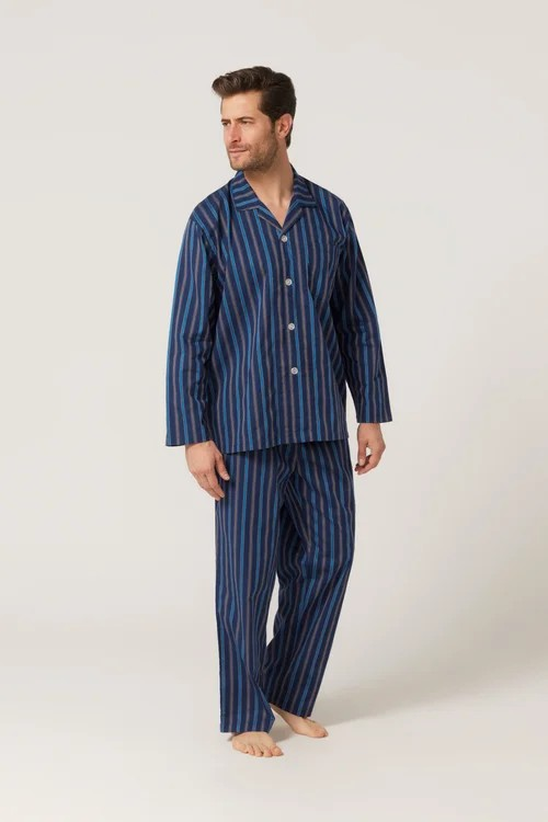 Man wearing a blue striped pajama set on a white background