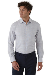 Man wearing a light gray checkered shirt and dark pants on a white background