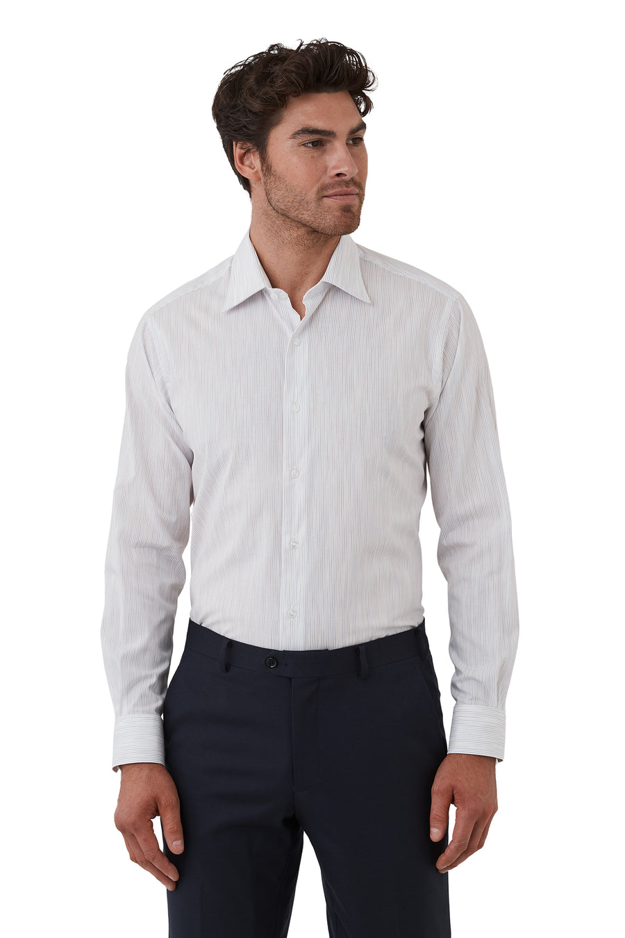 Man wearing a light gray dress shirt with a subtle pattern and dark pants on a white background