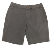 Gray shorts on a white surface with a textured gray background