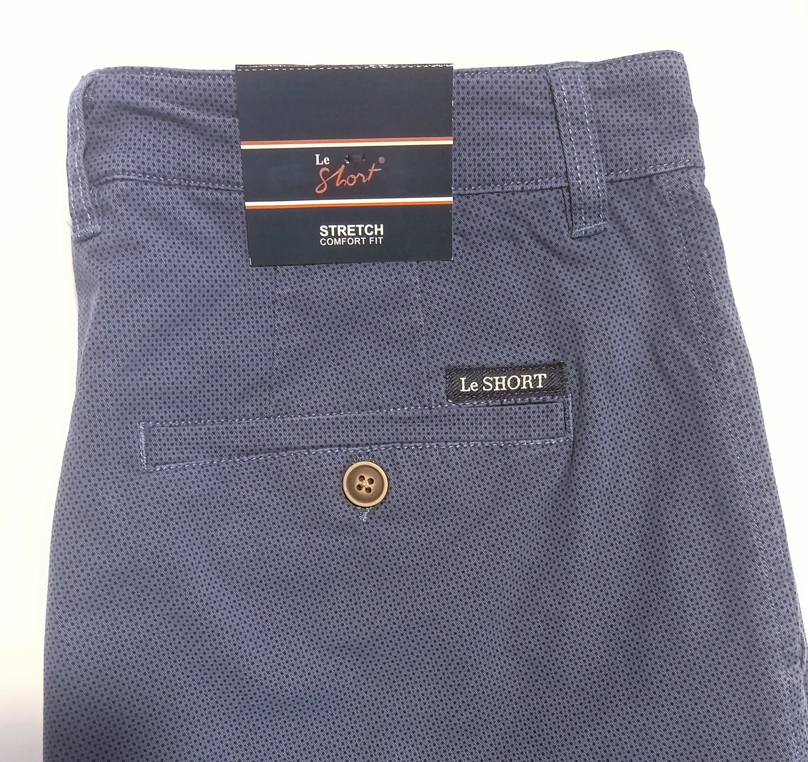 Close-up of the back waistband and pocket area of Le Short Stretch Comfort Trousers in a textured navy blue fabric, showing the brand labels and a brown button.