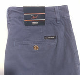 Close-up of the back waistband and pocket area of Le Short Stretch Comfort Trousers in a textured navy blue fabric, showing the brand labels and a brown button.