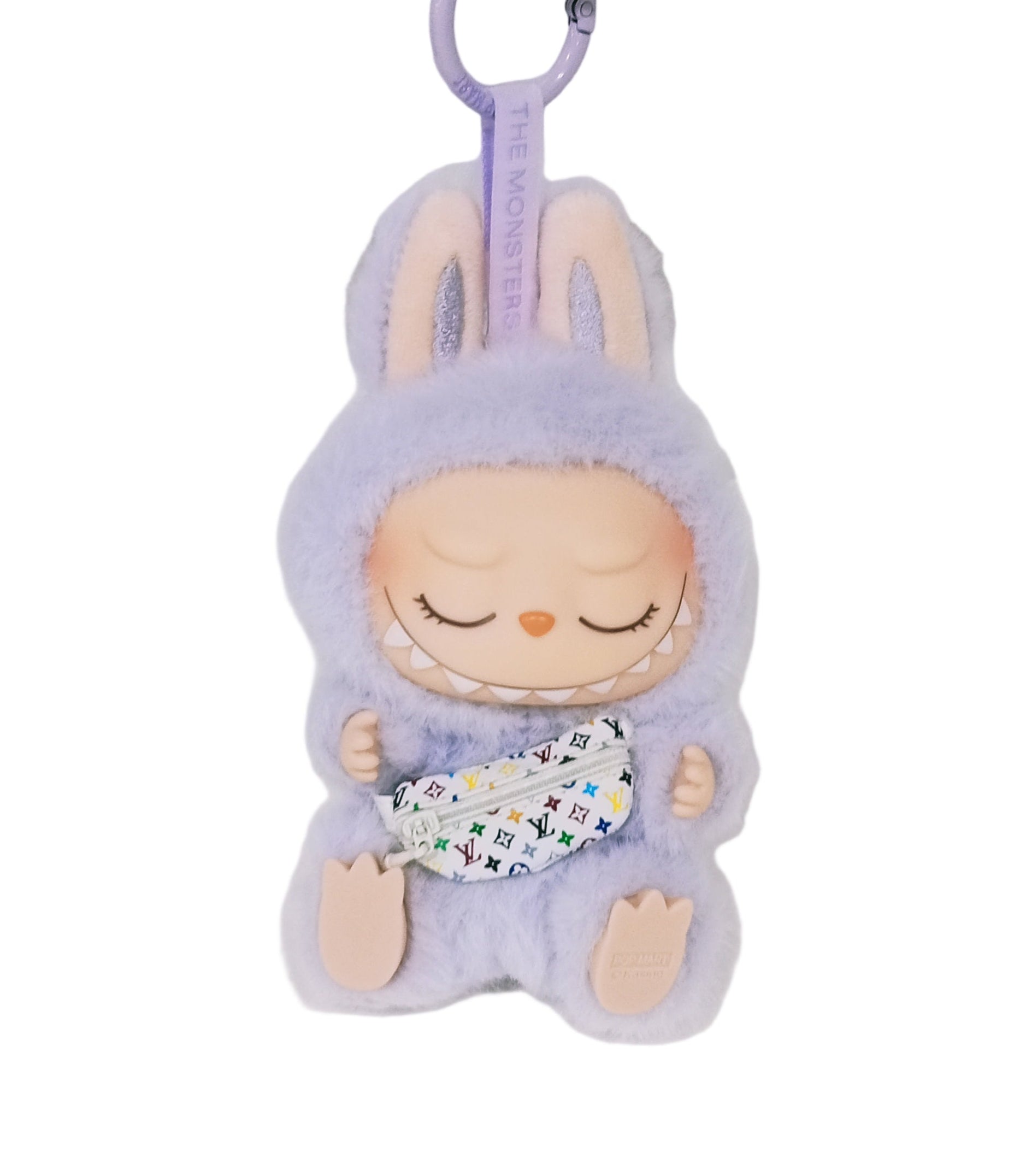 Keychain with a plush toy character in a purple outfit on a white background