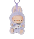 Keychain with a plush toy character in a purple outfit on a white background