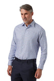 A man wearing a light blue and white checkered long-sleeve dress shirt with dark navy trousers, standing against a plain white background.