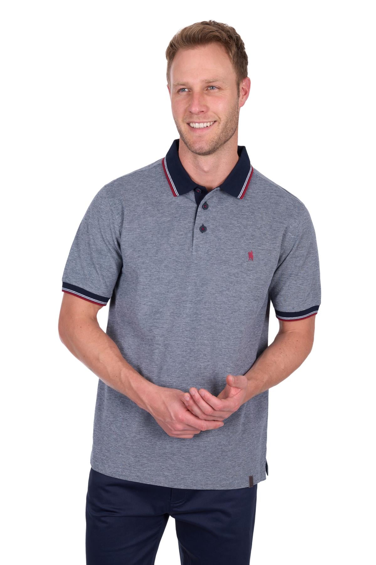 Man wearing a gray polo shirt with navy accents on a white background