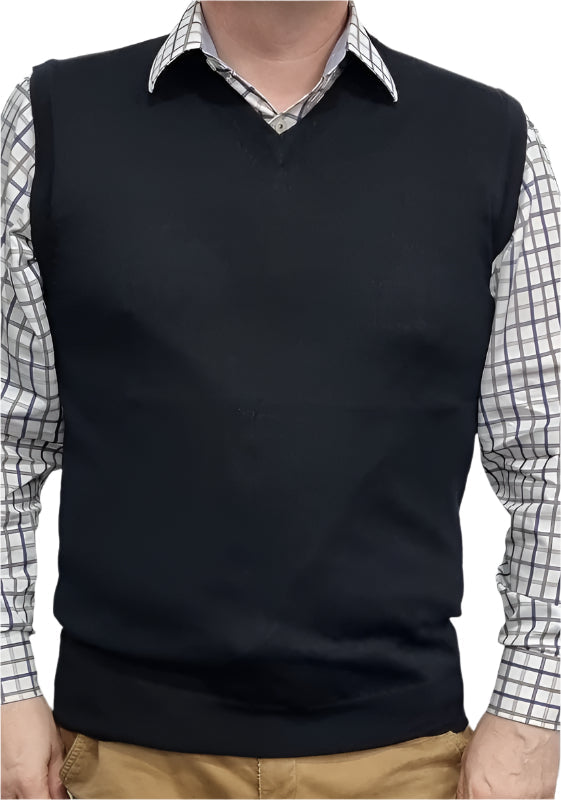 Person wearing a black sweater vest over a checkered shirt with a white background