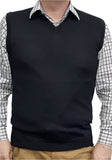 Person wearing a black sweater vest over a checkered shirt with a white background