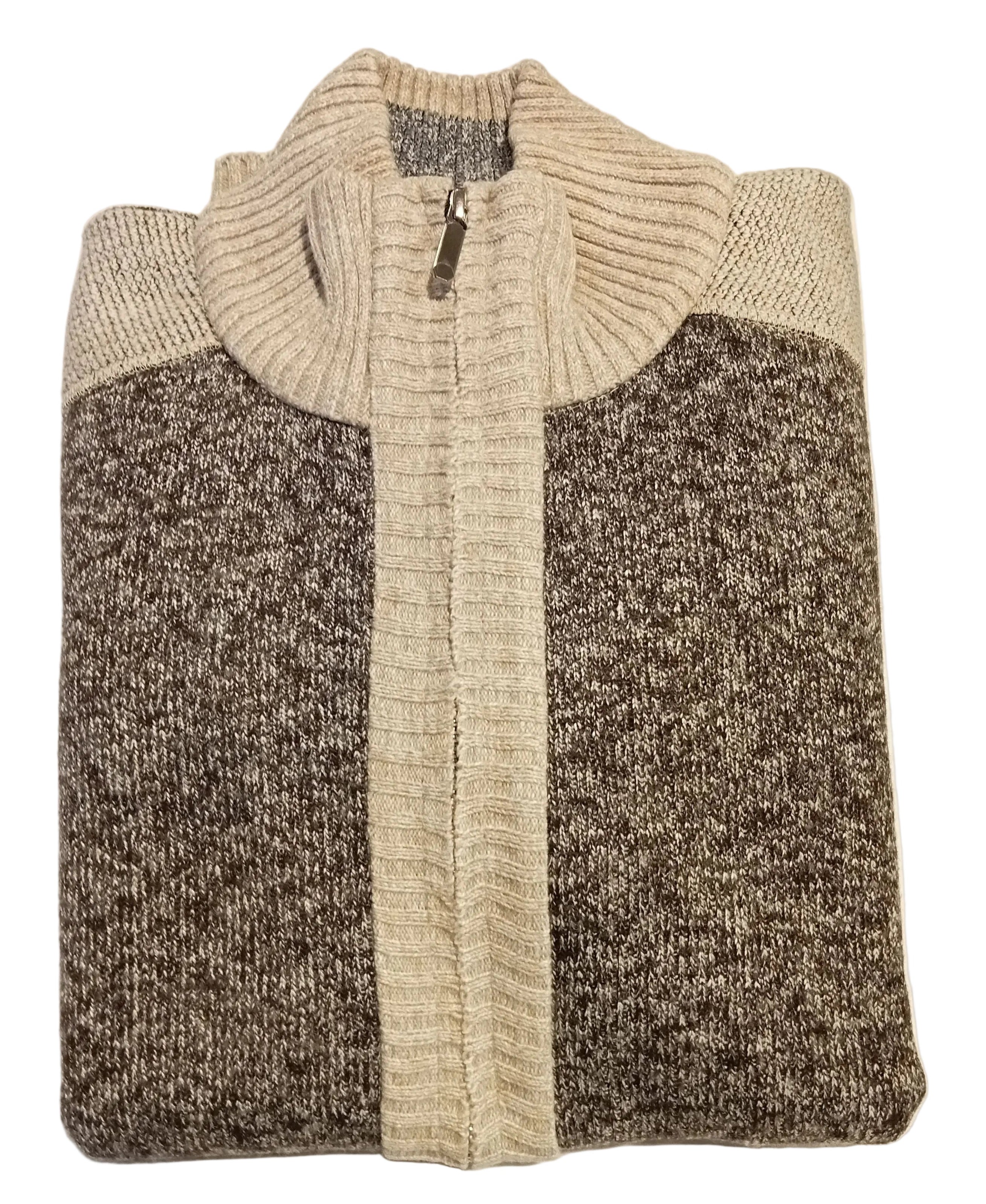 Folded sweater with a color block design on a white surface.