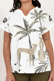 Person wearing a white shirt with cheetah and palm tree pattern