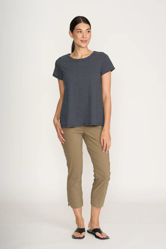 Woman wearing a striped shirt and beige pants on a white background