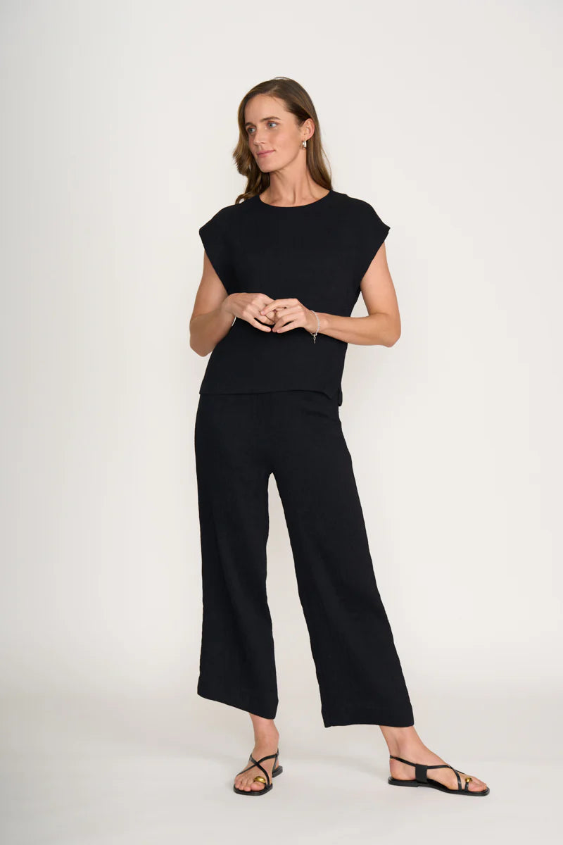 Woman wearing a black outfit on a white background