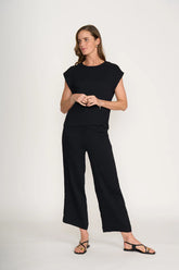 Woman wearing a black outfit on a white background