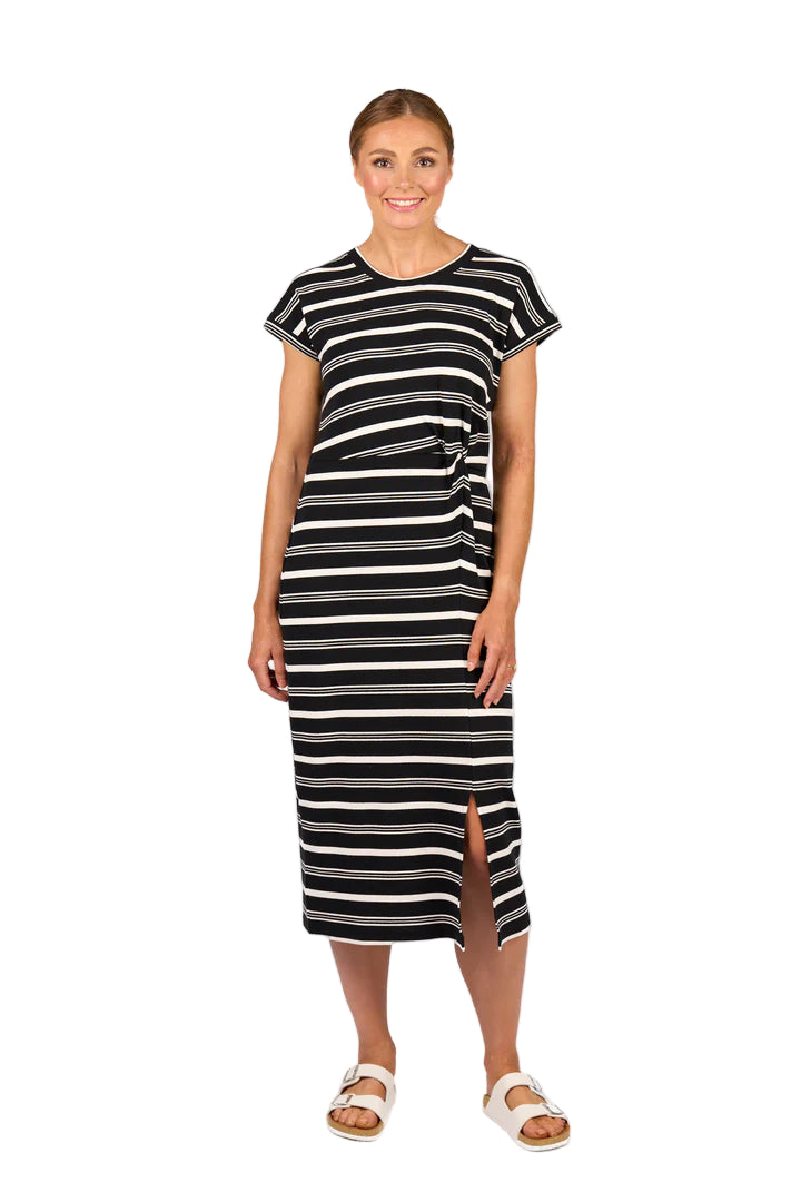 Woman wearing a black and white striped dress on a white background