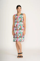Woman wearing a colorful sleeveless dress on a white background