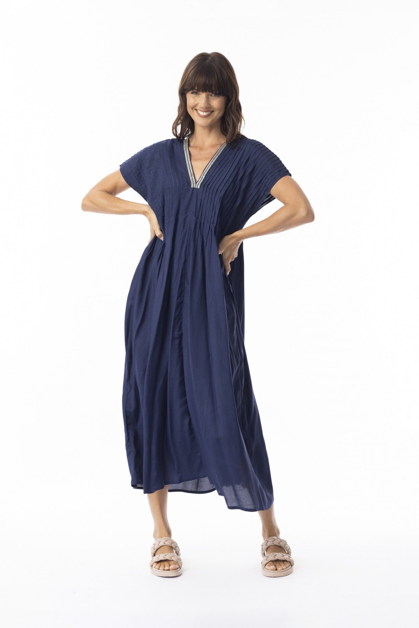 Woman wearing a navy blue dress on a white background