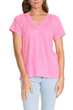 Woman wearing a pink t-shirt and light blue jeans on a white background