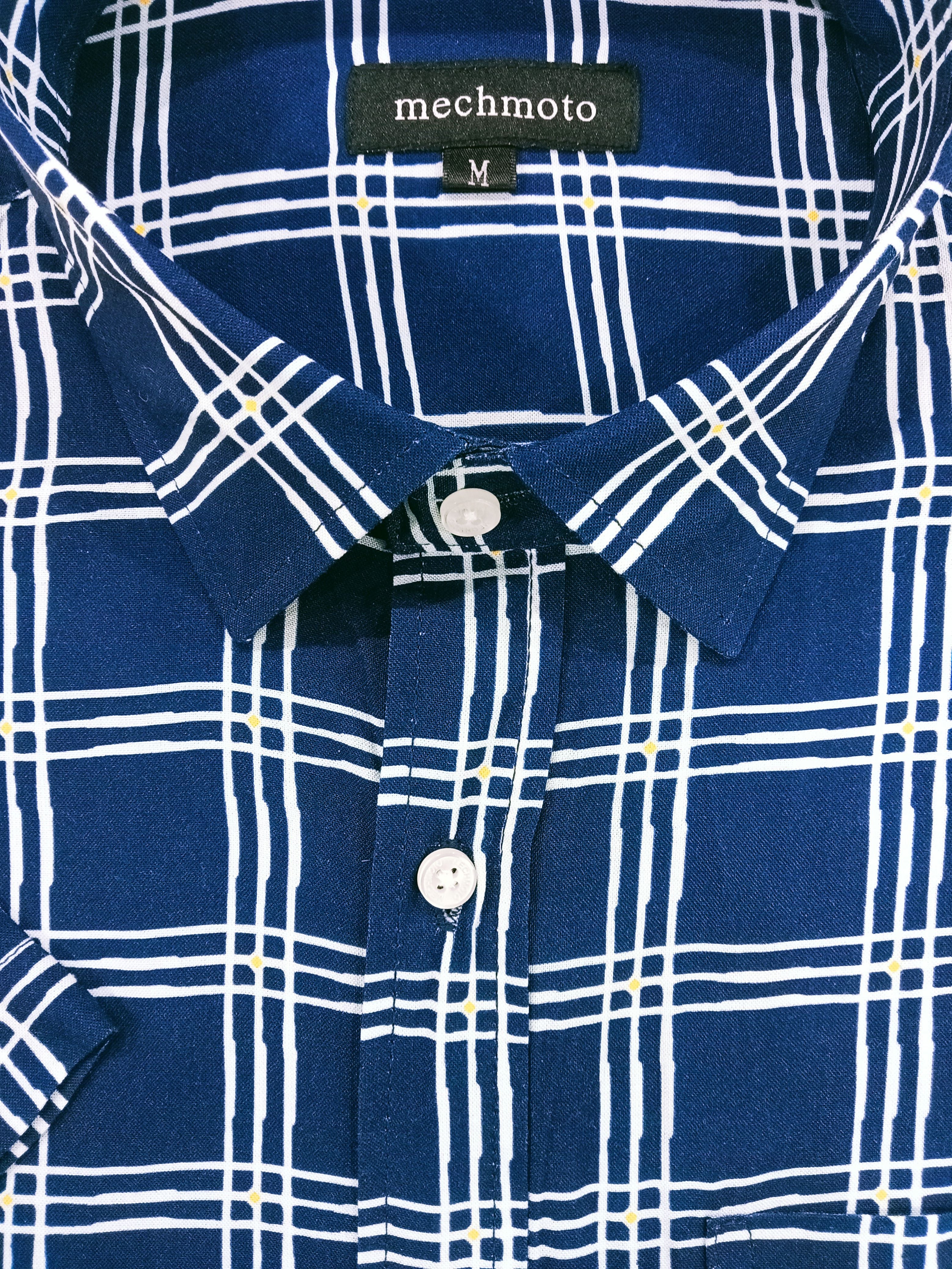 Close-up of a blue and white checkered shirt with 'mechmoto' label.