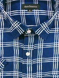 Close-up of a blue and white checkered shirt with 'mechmoto' label.