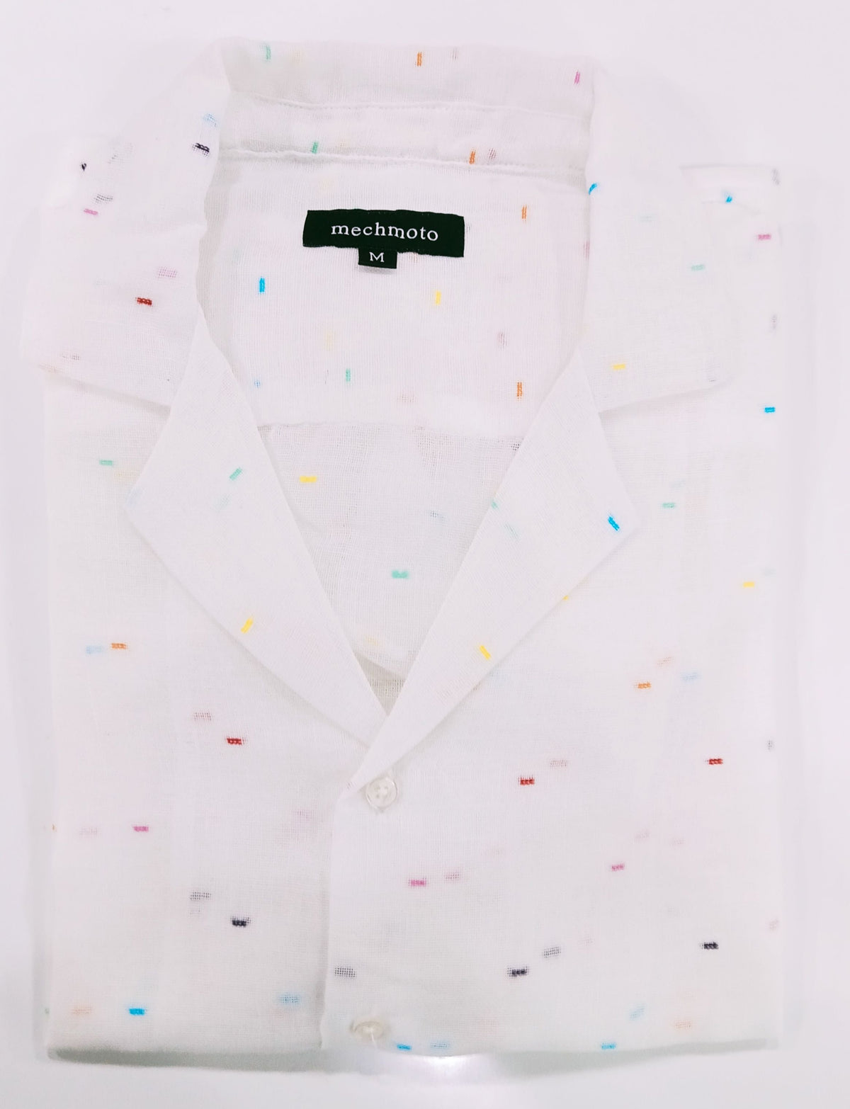 White shirt with colorful speckles on a white background