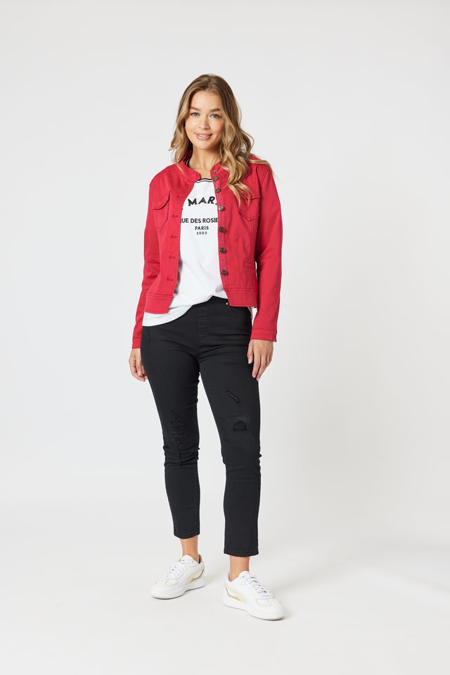 Woman wearing a red jacket, white t-shirt, black jeans, and white sneakers on a white background