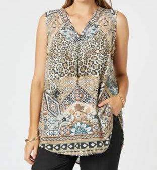 Woman wearing a patterned sleeveless top and black pants on a white background