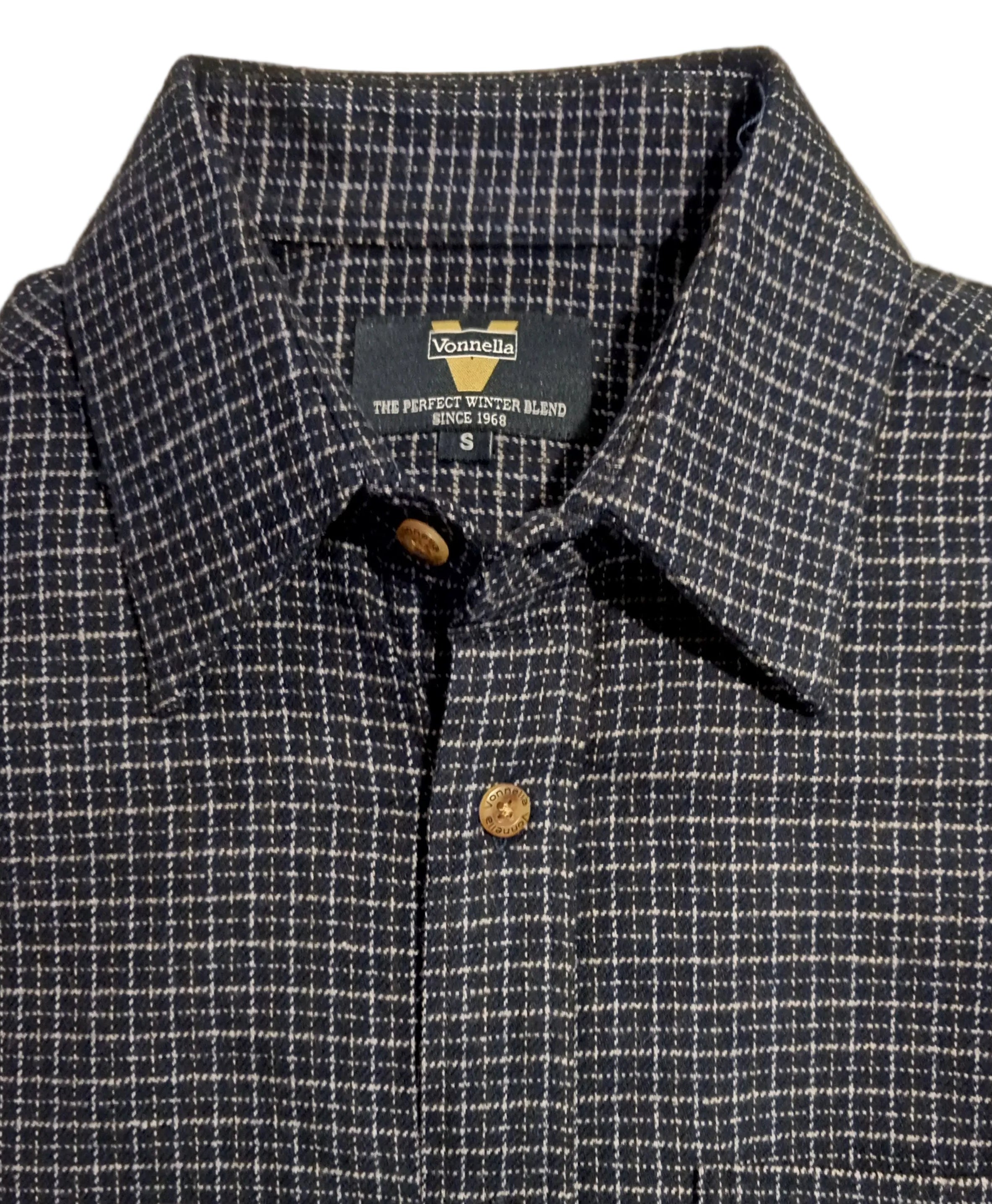 Plaid shirt with buttons on a white surface