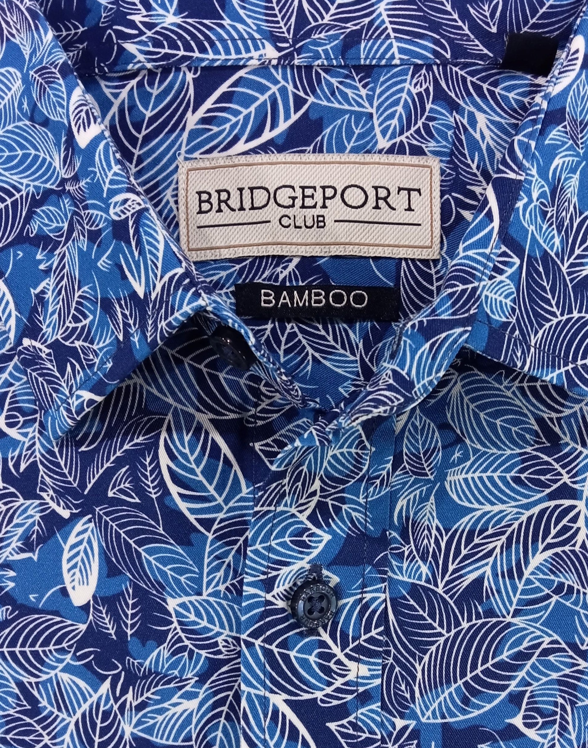 Blue patterned shirt with a visible brand label on a white background