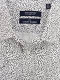 Close-up of a shirt with Bridgeport Club labels on a white and black patterned fabric.