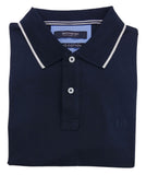Folded navy blue polo shirt with white trim on a light gray background