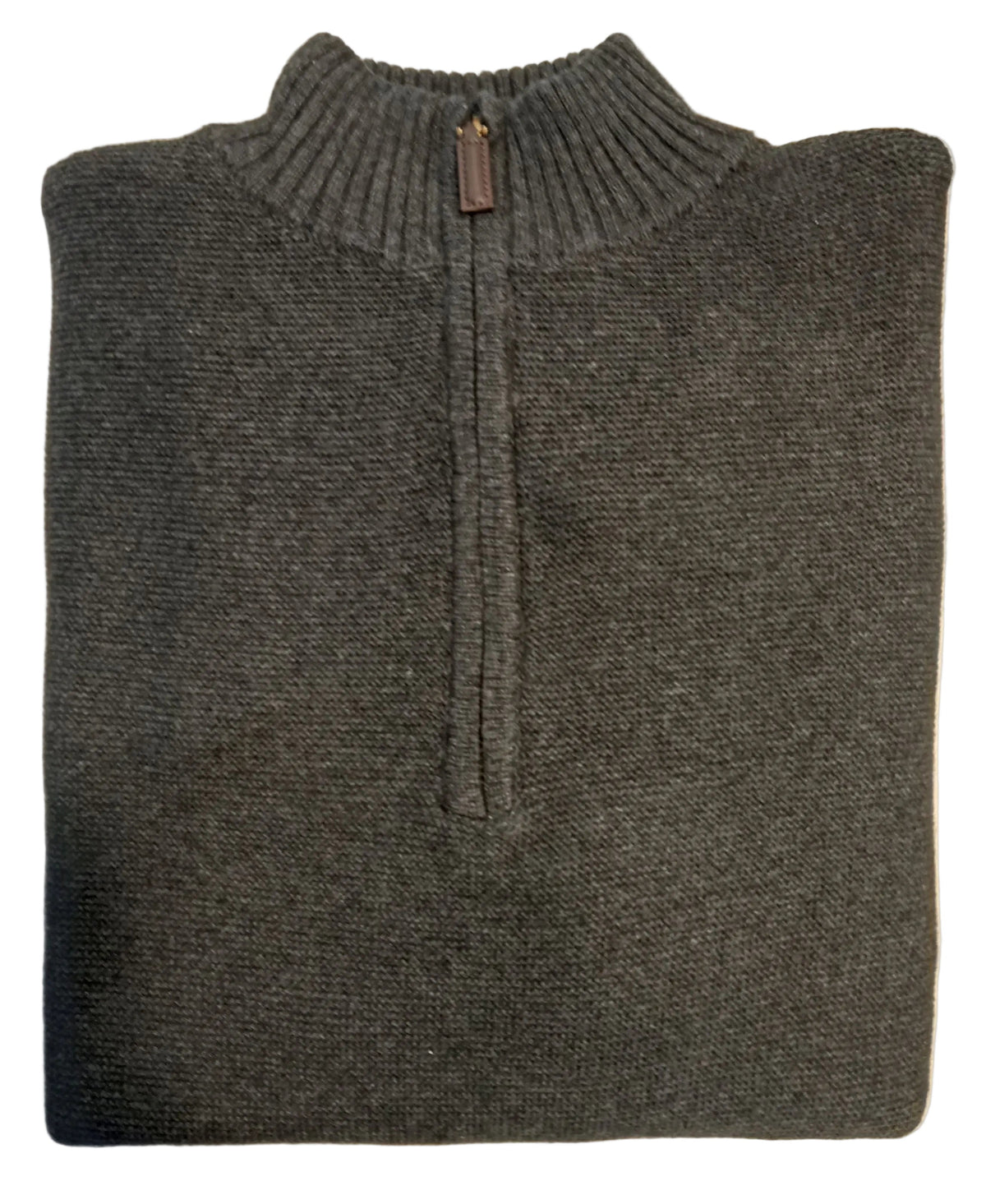 Folded gray sweater on a white surface with a blurred background